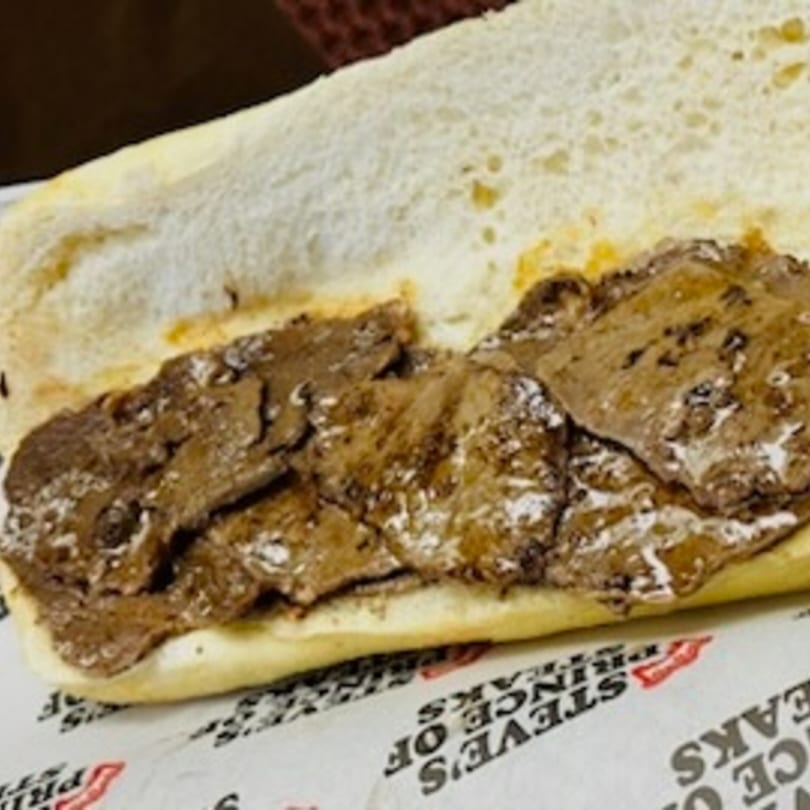 Steve's Prince of Steaks cheesesteak, with thinly sliced steak and melted cheese on a long roll.